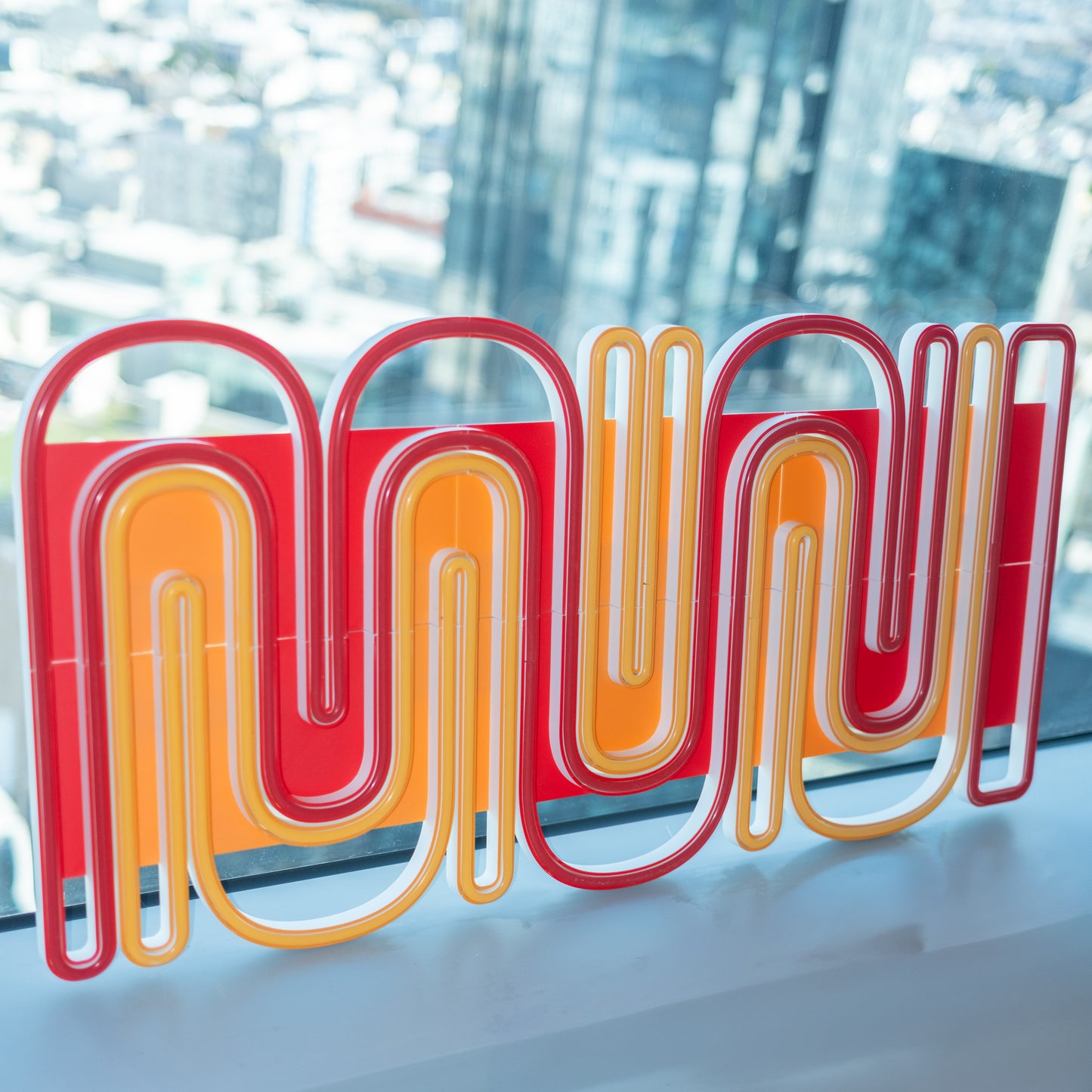 Muni LED sign with a blurred skyline in the background.